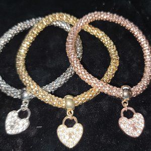 Set of three bracelets with rhinestone heart. Silver, Gold, Rose gold colours.